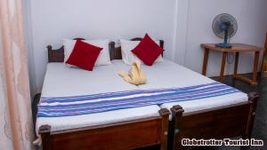 Postel nebo postele na pokoji v ubytování Globetrotter Tourist Inn
