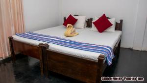 Postel nebo postele na pokoji v ubytování Globetrotter Tourist Inn