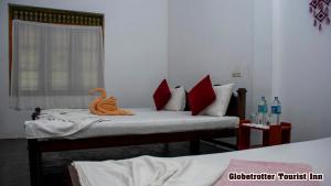 Postel nebo postele na pokoji v ubytování Globetrotter Tourist Inn