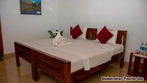 Postel nebo postele na pokoji v ubytování Globetrotter Tourist Inn