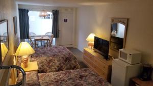 a hotel room with two beds and a television at Astronaut Motel in Wildwood Crest