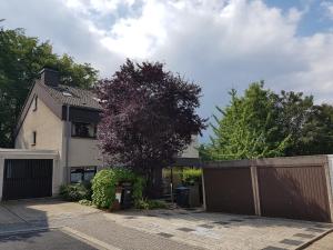 a house with a gate and a fence at Ferienwohnung mit eigenem Pool und finnischer Sauna in Witten in Witten
