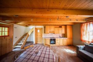 a tiny house with a staircase in a living room at Casa Ross da Fabio in Livigno