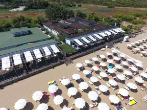 an aerial view of a beach with umbrellas at Valtur Baia del Gusmay Beach Resort in Peschici