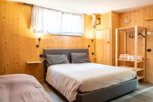 A bed or beds in a room at Baita Carnale, Montagna in Valtellina