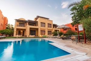 an image of a swimming pool in front of a house at El Gouna 2 bedrooms apartment South Marina Ground Floor in Hurghada