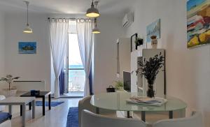 a living room with a glass table and chairs at Vlatkovićeva Apartments in Senj