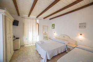 A bed or beds in a room at Olbia Domus Inn