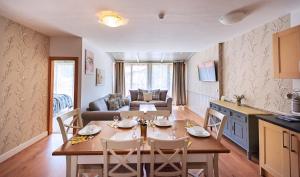 a kitchen and living room with a table and chairs at Mountain View Aparthotel in Bansko