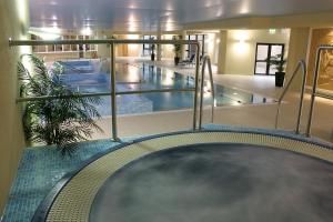 a large swimming pool in a large building with a pool at Amber Springs Hotel in Gorey