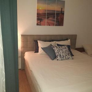 a bed with two pillows on it in a bedroom at Apartment Antonija in Povile