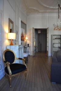 a living room with a chair and a couch at Burdigala Homes - Appart Duffour Dubergier in Bordeaux