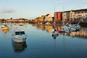 a group of boats are docked in a harbor at No 12 B&B in Dungarvan