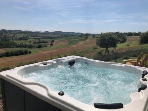a jacuzzi tub with a view of a field at Cascina Vicentini in Alfiano Natta