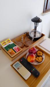 a desk with a tray of food and a remote control at Carducci 49 in Mantova