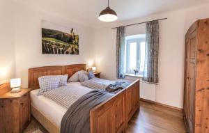 a bedroom with a wooden bed and a window at Schwalbennest Pongratz in Gamlitz