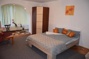 a bedroom with a bed and a table at Central Appartment St's Martin Church in Braşov
