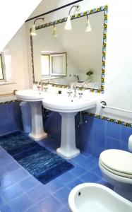 a bathroom with two sinks and a mirror at La Casa di Bianca in Caltagirone +30 photos