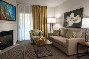 a living room with a couch and a fireplace at Tahiti All-Suite Resort in Las Vegas