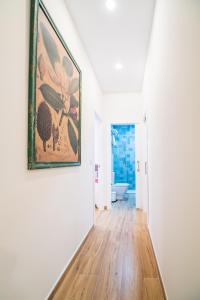 a living room with a painting on the wall at A&S APARTAMENTOS MALAGA I in Málaga