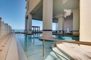 a swimming pool with a view of a building at Majestic Beach Resort in Panama City Beach