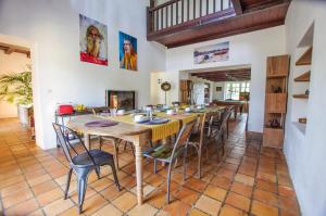 a large dining room with a long table and chairs at Logis Saint Léonard in Dompierre-sur-Mer