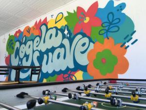 a wall with a flower mural on a wall at Hotel Restaurante Versalles in Melgar