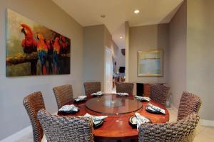 a dining room with a wooden table and chairs at Sapphire Bungalow #106 in South Padre Island