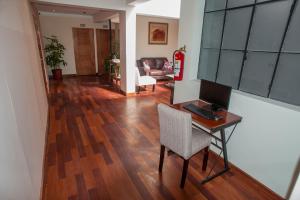 a living room with a desk with a computer on it at Casa Biru Hotel Boutique in Cusco