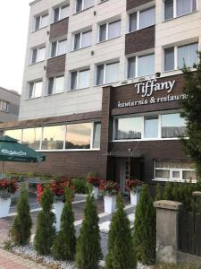 a building with a sign for a hotel at Hotel Tiffany in Nowe Miasto Lubawskie