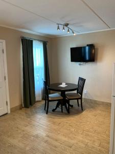 a dining room with a table and two chairs at Inn on the Gulf in Hudson