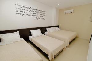 Voodi või voodid majutusasutuse Hotel Maranata Valledupar toas