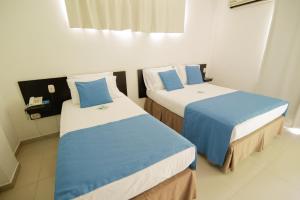 Voodi või voodid majutusasutuse Hotel Maranata Valledupar toas