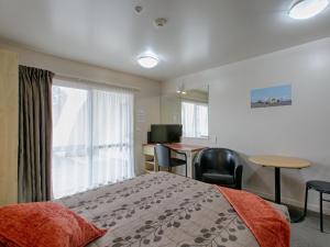 a hotel room with a bed and a desk at Bella Vista Hokitika in Hokitika
