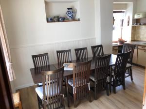 a dining room with a wooden table and chairs at vakantiehuismoezel in Sankt Aldegund