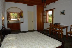 a bedroom with a bed and a table and chairs at Niriides Studios in Armenistis +32 photos