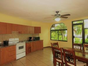 a kitchen with a table and a ceiling fan at Flamingo Marina Hotel in Playa Flamingo