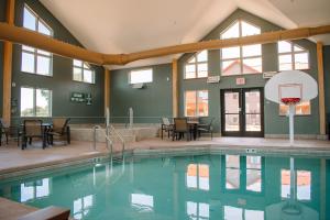 a swimming pool with a basketball hoop in a building at The Lodge at Mauston in Mauston