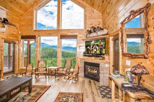 a dining room and living room with a fireplace in a log cabin at Bella Vista Lodge in Gatlinburg