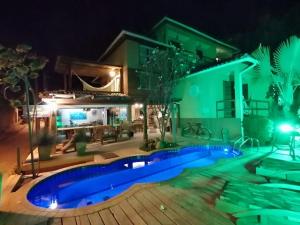 a swimming pool in front of a house at night at Pousada Bahia Bella in Morro de São Paulo