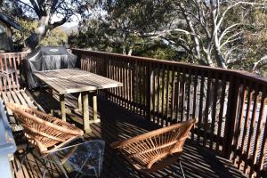 a wooden bench sitting on top of a wooden walkway at Pure Chalet Thredbo in Thredbo