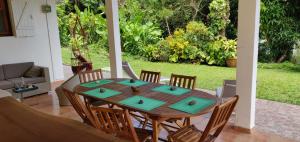 a wooden table and chairs in a yard at Escale Caraibes in Trois-Rivières