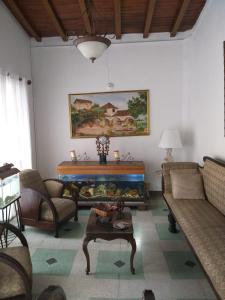 a living room with a couch and a table at Big House Medellin in Medellín