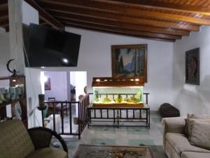 a living room with a fish tank and a tv at Big House Medellin in Medellín