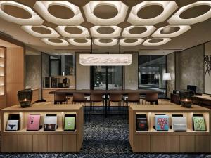 a lobby with a large chandelier and tables and chairs at Hotel Vischio Kyoto by GRANVIA in Kyoto
