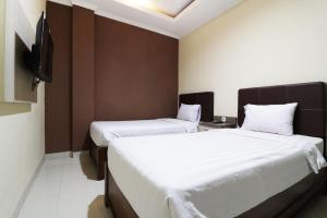Postel nebo postele na pokoji v ubytování Hotel Istana Bungur
