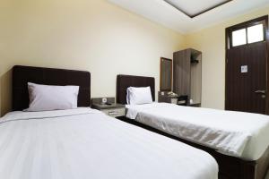 Postel nebo postele na pokoji v ubytování Hotel Istana Bungur