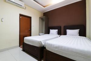 Postel nebo postele na pokoji v ubytování Hotel Istana Bungur