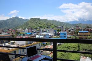 a view of a city from a balcony with a laptop at Hotel Lilyland Pvt Ltd in Pokhara