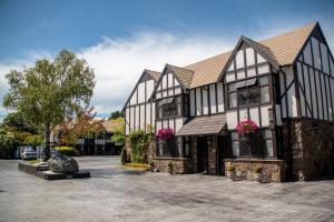 a large building with black and white at Scenic Hotel Cotswold in Christchurch
